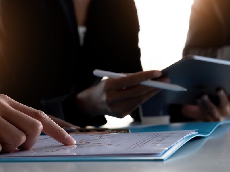 Asian business adviser meeting to analyze and discuss the situation on the financial report in the meeting room.Investment Consultant,Financial advisor and accounting concept.