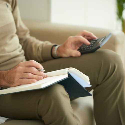 Cropped image of senior man counting his expences