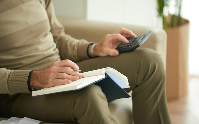 Cropped image of senior man counting his expences